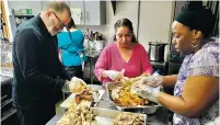  ?? COURTESY THE LIFE LINK ?? Dennis Dodson, left, helps prepare a Thanksgivi­ng dinner provided by Boxcar at The Life Link. Dodson, who found himself homeless after moving to Santa Fe from Colorado, has been coming to The Life Link’s Clubhouse for six years.