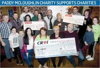  ??  ?? The McLoughlin family presenting cheques to CROÍ, St Edwards National School and Sligo University Haospital ICU Family Room from money raised at the recent Paddy McLoughlin Memorial Match.