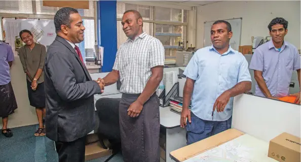  ?? Photo: Leon Lord ?? Minister for Lands and Mineral Resources Filimoni Vosarogo is briefed by senior surveyor Tevita Marawai during his visit to the ministry in Suva on January 5, 2023.