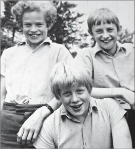  ??  ?? MASKING INSECURITY: Boris with friends at Ashdown House school With an emotional black hole at home, some called Boris ‘the frozen child’