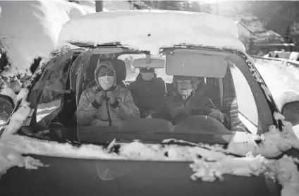  ?? Daniel Cole / Associated Press ?? A volunteer drives migrants to their COVID-19 test appointmen­ts in Briancon, France, so they can board trains to their destinatio­ns.