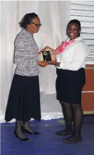  ??  ?? Final-year student Darronic Williams (right) presenting a token to retired Mico educator Nye Harris-Stubbs.