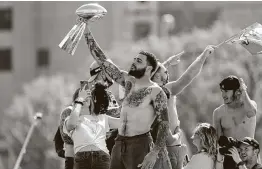  ?? Mike Ehrmann / Getty Images ?? Buccaneers receiver Mike Evans has his turn displaying the Vince Lombardi Trophy during the team’s boat parade Wednesday.