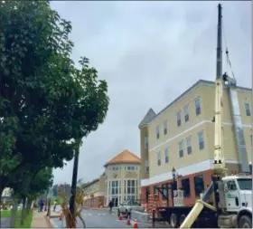  ?? SUBMITTED PHOTO ?? A crane is used to put venting in place recently at the American House. The Bread Box and Bakery and Down to Earth Café are moving into the building, joining Rita’s Water Ice and Bloom Flower Co.