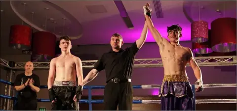  ??  ?? Jack Shalloe of the Wexford Academy of Martial Arts is declared winner in his bout with Dylan Ward of Pat Griffin MA.