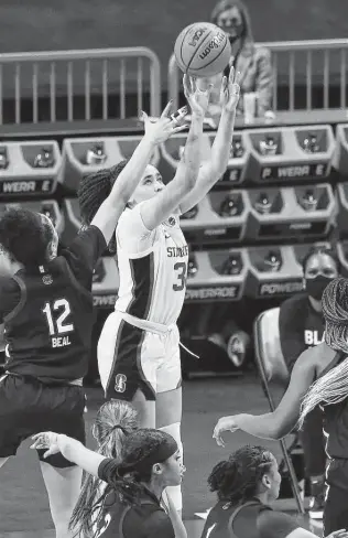  ?? Kin Man Hui / Staff photograph­er ?? Stanford’s Haley Jones, who scored 24 points on 11-of-14 shooting, hits the go-ahead shot with 32 seconds remaining over South Carolina’s Brea Beal during a Final Four semifinal on Friday.