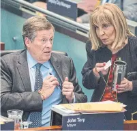  ??  ?? Mayor John Tory and Councillor Frances Nunziata discuss the city budget, which was approved by a 21-4 vote Thursday.