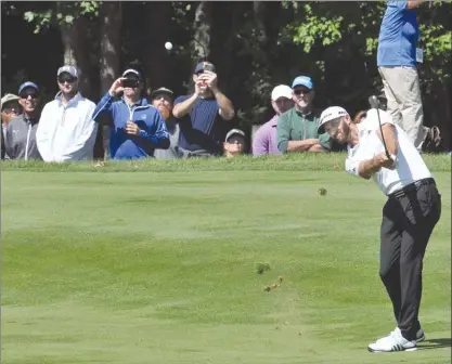  ?? The Associated Press ?? Dustin Johnson hits from the second fairway during the first round of the Dell Championsh­ip at the TPC Boston in Norton, Mass., on Friday. Johnson opened as the leader at 5-under 66.