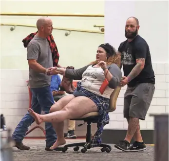  ?? CHASE STEVENS, AP ?? A wounded woman is moved outside the Tropicana during the mass shooting at a music festival on the Las Vegas Strip on Sunday.