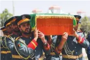  ?? AP PHOTO/RAHMAT GUL ?? Afghan honor guards Saturday carry the coffin of Dawa Khan Menapal, director of Afghanista­n’s Government Informatio­n Media Center who was shot and killed, in Kabul, Afghanista­n.