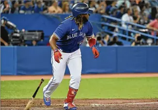  ?? JON BLACKER/THE CANADIAN PRESS VIA AP ?? The Blue Jays’ Vladimir Guerrero Jr. watches his solo home run against the Minnesota Twins during the third inning Friday in Toronto. He leads the majors in hitting with a .321 average.