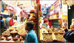  ?? CHANDAN KHANNA/AFP ?? Indian sellers interact with customers in their shop in the old quarters of New Delhi on January 31.