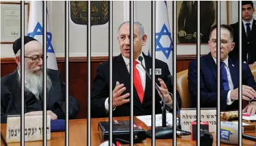  ?? (Mack Ishmael Seldom) ?? PRIME MINISTER Benjamin Netanyahu, or as he is known on the inside – Prisoner #5479 – convenes his first cabinet at the makeshift Prime Minister’s Office at Sharon Prison.