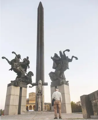  ?? PHOTOS: DINA MISHEV/THE WASHINGTON POST ?? The author’s father, who fled Bulgaria at 14, takes in the Asenevtsi Monument, built to commemorat­e the 800th anniversar­y of the uprising that led to the country’s liberation.