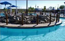  ?? PHOTO MICHAEL MARESH ?? the figure-eight shaped lazy river at the new el Center Aquatic Center was a popular attraction for younger children at saturday’s grand opening.