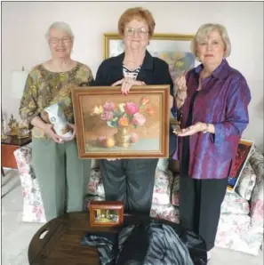  ?? CAROL ROLF/CONTRIBUTI­NG
PHOTOGRAPH­ER ?? Conway Symphony Orchestra Guild members, from the left, Patsy Desaulnier­s, Mary Mosley and Beverley Freiley display some of the items that will be up for bid Thursday at All That Jazz. The fundraisin­g event will be held at the Southweste­rn Energy Co....