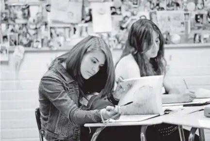  ??  ?? Wheat Ridge High School students Esmeralda Garcia, left, and Elizabeth Castellano­s complete class work during Stephanie Rossi’s sophomore Advanced Placement U.S. history class Thursday. Andy Cross, The Denver Post