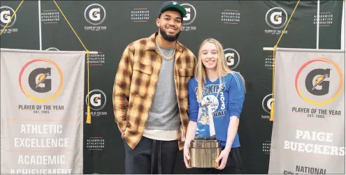  ?? Gatorade ?? UConn signee Paige Bueckers is surprised by NBA star Karl-Anthony Towns as she receives the Gatorade National Player of the Year Award on March 9. UConn Hall of Famer Rebecca Lobo says of Bueckers: “People all over knew what she looks like. They knew who she was. They knew how she plays. She’s a freshman. That couldn’t have existed for some of the other players who came to UConn, because social media wasn’t available. There is a whole nother level of awareness and I suppose the pressure that will come with that, depending on if she sees it as pressure.”