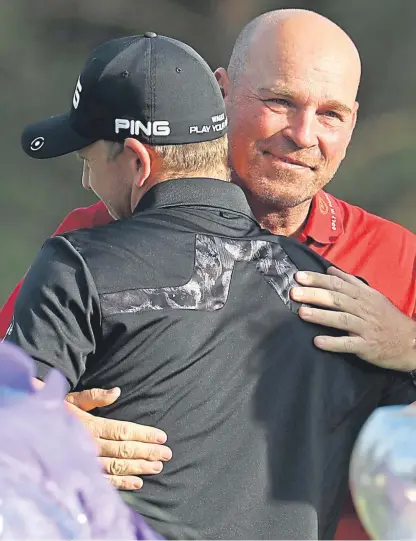  ?? Picture: Getty. ?? Matt Wallace gets the congratula­tions of Europe Ryder Cup captain Thomas Bjorn.