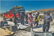  ?? THE NEW YORK TIMES /MERIDITH KOHUT ?? Members of a rescue team from Miami work in McLean’s Town, on Grand Bahama, the Bahamas, on Sept. 7.