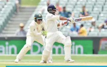  ??  ?? ADELAIDE: India’s Ajinkya Rahane plays a shot in front of Australia’s captain Tim Paine during day four of the first Test cricket match at the Adelaide Oval yesterday. — AFP
