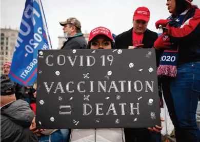  ??  ?? DEADLY CONSPIRACY THEORY
An anti-vaxxer at a MAGA rally in Washington, D.C. A Pew poll in December found roughly 50 million Americans are planning to abstain from vaccinatio­n, threatenin­g herd immunity.
