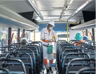  ?? /Reuters ?? Safety protocols: A mine worker wearing a face mask boards a bus ahead of his shift, amid the nationwide coronaviru­s lockdown, at a SibanyeSti­llwater mine in Carletonvi­lle on May 19 2020.