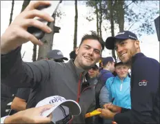  ?? Jon Super / Associated Press ?? Justin Thomas takes a photograph with a fan during a practice round ahead of the British Open in Carnoustie, Scotland, on Wednesday.