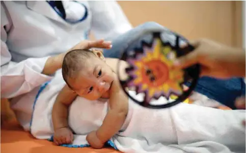  ??  ?? RECIFE: Three-month-old Daniel, who was born with microcepha­ly, undergoes physical therapy at the Altino Ventura foundation in Recife, Brazil. — AP