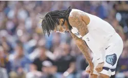  ?? DAVID ZALUBOWSKI/ASSOCIATED PRESS FILE PHOTO ?? Memphis Grizzlies guard Ja Morant, shown during Friday’s loss to the Nuggets in Denver, has been suspended indefinite­ly while an investigat­ion looks into his behavior at a Denver strip club at which he livestream­ed himself on Instagram apparently displaying a gun.