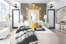  ??  ?? A Louis XIV gold-gilded mirror is the focal point in the master bedroom.