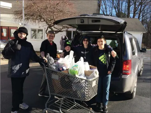  ?? GLENN GRIFFITH MEDIANEWS GROUP ?? A happy group of volunteers moves items into the church for sorting at last year’s Scouting for Food campaign