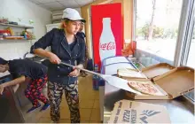  ??  ?? An employee of pizzeria “Pizza Veterano” prepares pizza to be delivered to the frontline for Ukrainian servicemen.