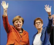  ?? AP 2017 ?? Annegret Kramp-Karrenbaue­r, right, making a public appearance with German Chancellor Angela Merkel, has been dubbed “mini-Merkel” by the German media, but some analysts say the new general-secretary deserves credit for her own brand of political acumen.