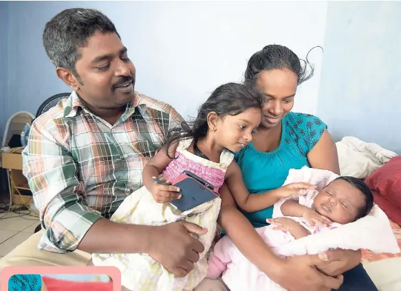  ?? PHOTOS BY GLADSTONE TAYLOR/FREELANCE PHOTOGRAPH­ER ?? Parents Milton and Angel Praba Maxwell share how life has been since having their stolen baby Danisha returned. Their first child, Marisha, plays with her baby sister