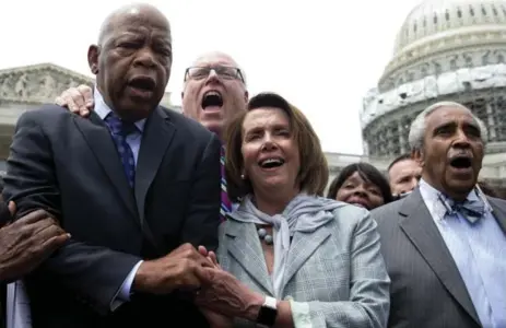  ?? CAROLYN KASTER/THE ASSOCIATED PRESS ?? From left, Rep. John Lewis, Rep. Joseph Crowley, House Minority Leader Nancy Pelosi of California and Rep. Charles Rangel sing "We Shall Overcome.”