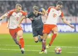  ?? PHOTO: AFP ?? (From left) Bayern Munich’s Matthijs de Ligt, Arsenal’s Martin Odegaard and Bayern’s Leon Goretzka vie for the ball during the Uefa Champions League quarterfin­al, second leg in Munich, Germany, on Wednesday.