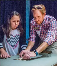  ?? WILLIAM HARVEY/THREE RIVERS EDITION ?? Serena Murphy, a second-grader at Sidney Deener Elementary School, prepares to adjust her pumpkin catapult with the help of Ben Carrigan, science instructio­n specialist at the Harding University Finley STEM Center.