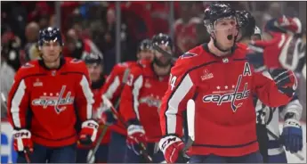  ?? (AP PHOTO/JOHN MCDONNELL) ?? Washington Capitals defenseman John Carlson, right, celebrates his go-ahead goal against the Tampa Bay Lightning during Saturday’s game in Washington