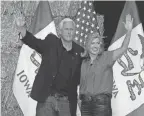  ?? CHARLIE NEIBERGALL/AP ?? Former Vice President Mike Pence stands on stage with U.S. Sen. Joni Ernst, R-Iowa, during her Roast and Ride event Saturday in Des Moines, Iowa. Pence made his candidacy for president official on Monday.