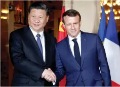  ?? — Reuters photo ?? Macron shakes hands with Xi as he arrives for a dinner at the Villa Kerylos in Beaulieu-surMer, near Nice, France.
