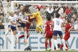  ?? AP photos ?? The United States’ Julie Ertz (from left) and Alex Morgan collide with Vietnam goalkeeper Thi Kim Thanh Tran during the first half today.