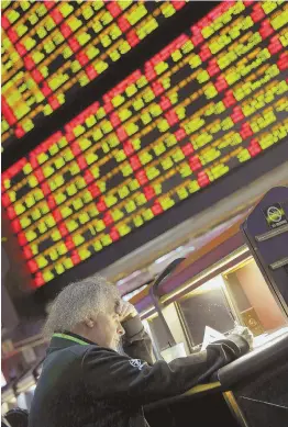  ?? AP FILE PHOTO ?? STATE POTENTIAL: A man looks through Super Bowl propositio­n bets in Las Vegas. Sports betting could be legal in Massachuse­tts this NFL season.