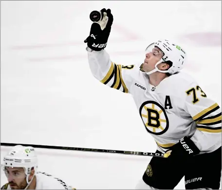  ?? NICK WASS — THE ASSOCIATED PRESS ?? Boston Bruins defenseman Charlie McAvoy (73) grabs the puck during the third period of an NHL hockey game against the Washington Capitals, Monday, April 15, 2024, in Washington.