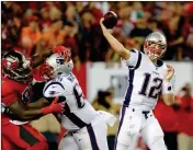  ?? ASSOCIATED PRESS ?? NEW ENGLAND PATRIOTS QUARTERBAC­K Tom Brady (12) throws a pass as offensive guard Shaq Mason (69) blocks Tampa Bay Buccaneers defensive end Robert Ayers (left) during the first half Thursday in Tampa, Fla.