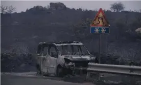  ?? Perrone/Getty Images ?? A car left destroyed by the blaze in the province of Oristano. Photograph: Emanuele