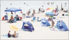 ?? Associated Press ?? People enjoy a beach day on the New Jersey shore earlier this month.