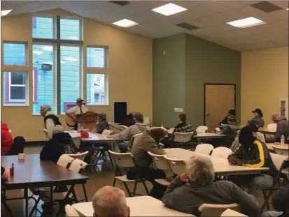  ?? COURTESY OF THE EUREKA RESCUE MISSION ?? People sheltering at the Eureka Rescue Mission practice social distancing while listening to music in the shelter’s cafeteria on Tuesday. Local shelters, including the Eureka Rescue Mission, are no longer accepting new clients and are asking the people they’re already serving to shelter in place in order to curb the spread of the COVID-19 disease, caused by the novel coronaviru­s.