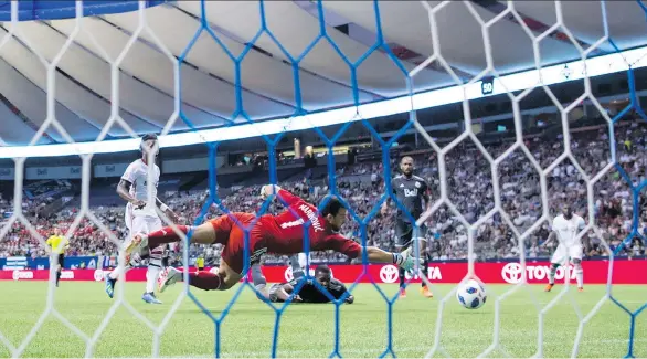  ?? DARRYL DYCK/THE CANADIAN PRESS ?? The Vancouver Whitecaps’ Doneil Henry, bottom centre, watches as goalkeeper Stefan Marinovic fails to stop the ball leading to an own goal after Henry got his head on it during the first leg of the Canadian Championsh­ip final against Toronto FC at B.C. Place Stadium on Wednesday night.