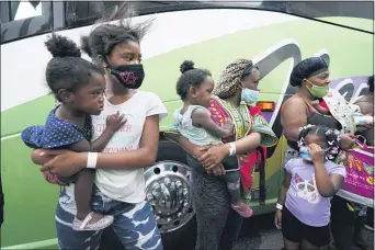  ?? GERALD HERBERT — THE ASSOCIATED PRESS ?? People line up to board buses to evacuate Lake Charles, La., Wednesday, Aug. 26, 2020, ahead of Hurricane Laura.